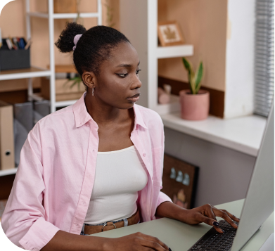 A woman using a laptop in an office environment.