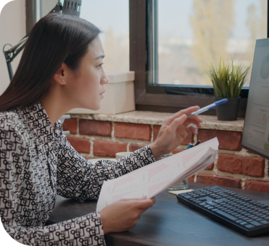 Woman comparing print and digital information: Analyzing data for informed decisions.